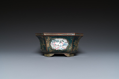 A Chinese Canton enamel gilt-decorated dark-green-ground jardini&egrave;re with four inserted plaques, Qianlong/Jiaqing