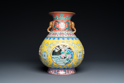 A Chinese reticulated and revolving famille rose vase consisting of two parts, Qianlong mark, 20th C.