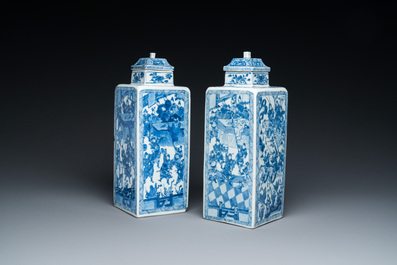 A pair of Chinese blue and white square 'narrative subject' vases and covers, Kangxi