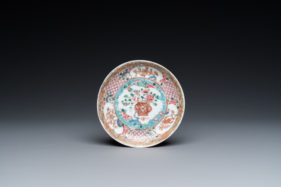 A Chinese famille rose ruby-ground cup and saucer, Yongzheng