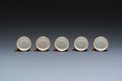 Onze soucoupes et dix tasses en porcelaine de Chine monogramm&eacute;es 'PM' sur fond dor&eacute;, Yongzheng/Qianlong