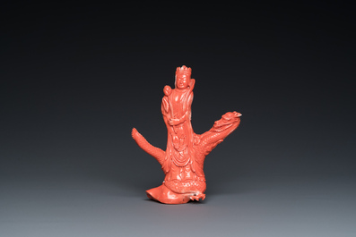 A Chinese red coral group of a standing prince on a dragon, 19/20th C.