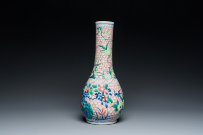 A Chinese wucai bottle vase with birds surrounded by fruits and foliage, Transitional period