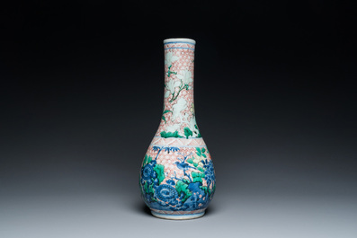 A Chinese wucai bottle vase with birds surrounded by fruits and foliage, Transitional period