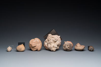 Acht diverse gesculpteerde stenen hoofden, o.a. Gandhara, Etruskisch, Japans en Chinees