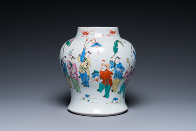 A Chinese famille rose 'playing boys' vase on a fine carved wooden stand, Yongzheng