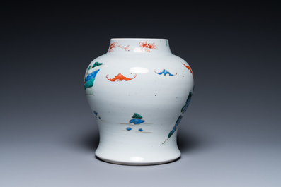 A Chinese famille rose 'playing boys' vase on a fine carved wooden stand, Yongzheng