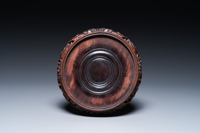 A Chinese famille rose 'playing boys' vase on a fine carved wooden stand, Yongzheng