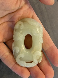 A Chinese 'twin chilong&rsquo; white jade circular pendant, Qing