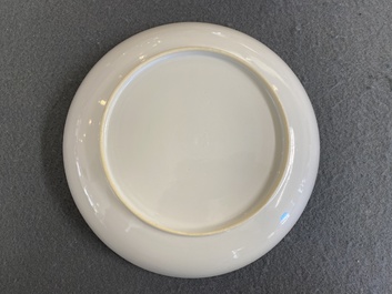 A fine Chinese famille rose eggshell porcelain plate with a boy and two governesses in an interior, Yongzheng