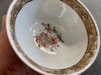 A Chinese famille rose ruby-ground cup and saucer, Yongzheng