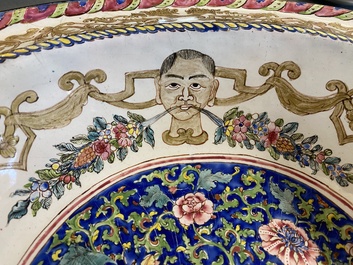 A large Chinese Canton enamel basin with garlands decorated with male heads, Qianlong