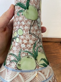 A Chinese wucai bottle vase with birds surrounded by fruits and foliage, Transitional period
