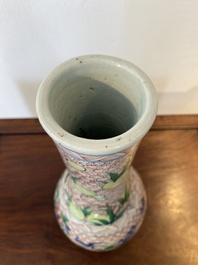 A Chinese wucai bottle vase with birds surrounded by fruits and foliage, Transitional period