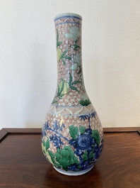 A Chinese wucai bottle vase with birds surrounded by fruits and foliage, Transitional period