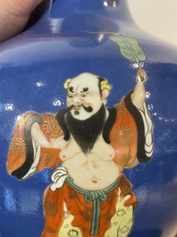 A Chinese blue-ground famille rose 'eight immortals' bottle vase, Qianlong mark, 19th C.