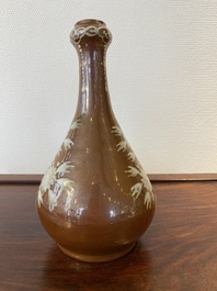 A Chinese slip-decorated brown-ground bottle vase, Zhushan kilns, late Ming