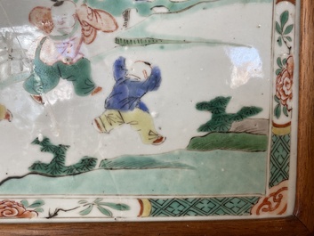 A Chinese famille verte plaque set in a partly huanghuali wooden table screen, Kangxi