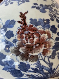 A Chinese blue, white and copper-red bottle vase with a deer and birds among blossoming branches, 19th C.
