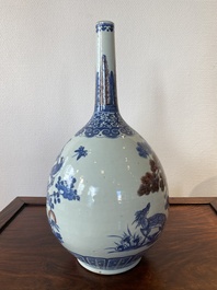 A Chinese blue, white and copper-red bottle vase with a deer and birds among blossoming branches, 19th C.
