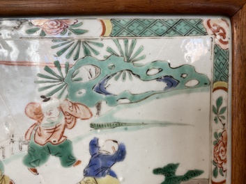 A Chinese famille verte plaque set in a partly huanghuali wooden table screen, Kangxi