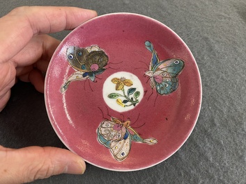 A rare Chinese famille rose ruby-ground 'three butterflies' saucer, Yongzheng