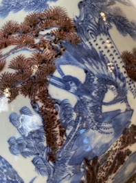 A Chinese blue, white and copper-red bottle vase with a deer and birds among blossoming branches, 19th C.