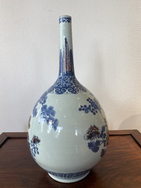 A Chinese blue, white and copper-red bottle vase with a deer and birds among blossoming branches, 19th C.