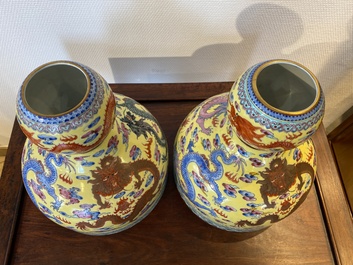 A pair of Chinese famille rose yellow-ground 'dragon' vases, Qianlong mark, 20th C.