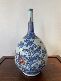 A Chinese blue, white and copper-red bottle vase with a deer and birds among blossoming branches, 19th C.