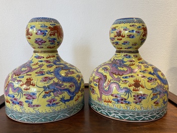 A pair of Chinese famille rose yellow-ground 'dragon' vases, Qianlong mark, 20th C.