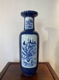 A Chinese blue-ground rouleau vase with blue and white landscape panels, 19th C.