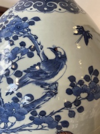 A Chinese blue, white and copper-red bottle vase with a deer and birds among blossoming branches, 19th C.