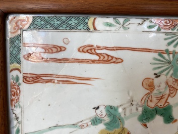 A Chinese famille verte plaque set in a partly huanghuali wooden table screen, Kangxi