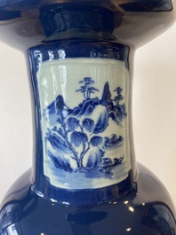 A Chinese blue-ground rouleau vase with blue and white landscape panels, 19th C.