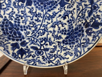 A Chinese blue and white 'peony scroll' dish and a famille verte dish, Kangxi