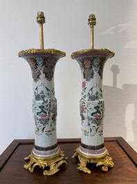 Paire de vases en porcelaine de Chine famille rose mont&eacute;s en lampes en bronze dor&eacute;, Yongzheng