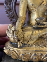 A Sino-Tibetan gilt and silvered copper alloy Medicine Buddha or Bhaishajyaguru, 19th C.