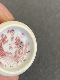 A Chinese blue, white and copper-red 'dogs' snuff bottle, 19th C.