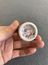 A Chinese blue, white and copper-red 'dogs' snuff bottle, 19th C.