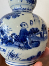 A Chinese blue and white double gourd vase with a scholar and two students, Transitional period