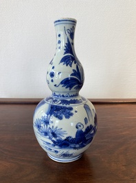 A Chinese blue and white double gourd vase with a scholar and two students, Transitional period
