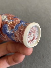 A Chinese blue, white and copper-red 'dogs' snuff bottle, 19th C.