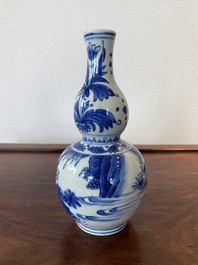 A Chinese blue and white double gourd vase with a scholar and two students, Transitional period