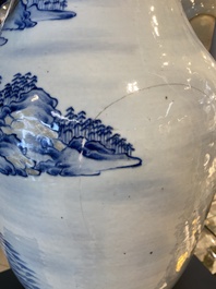 A large Chinese blue, white and copper-red vase with a mountainous river landscape, 19th C.