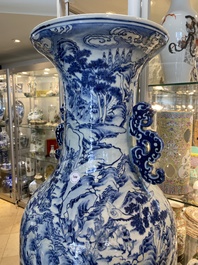 A large Chinese blue, white and copper-red vase with a mountainous river landscape, 19th C.