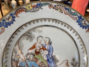 A pair of fine Chinese famille rose plates with a musician playing in front of a couple, Qianlong