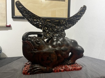 A large Chinese lacquered wooden stand in the shape of a three-legged toad, Ming