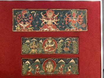 Eight tsaklis and three painted wood book covers, Tibet, 19th C.