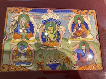 Eight tsaklis and three painted wood book covers, Tibet, 19th C.
